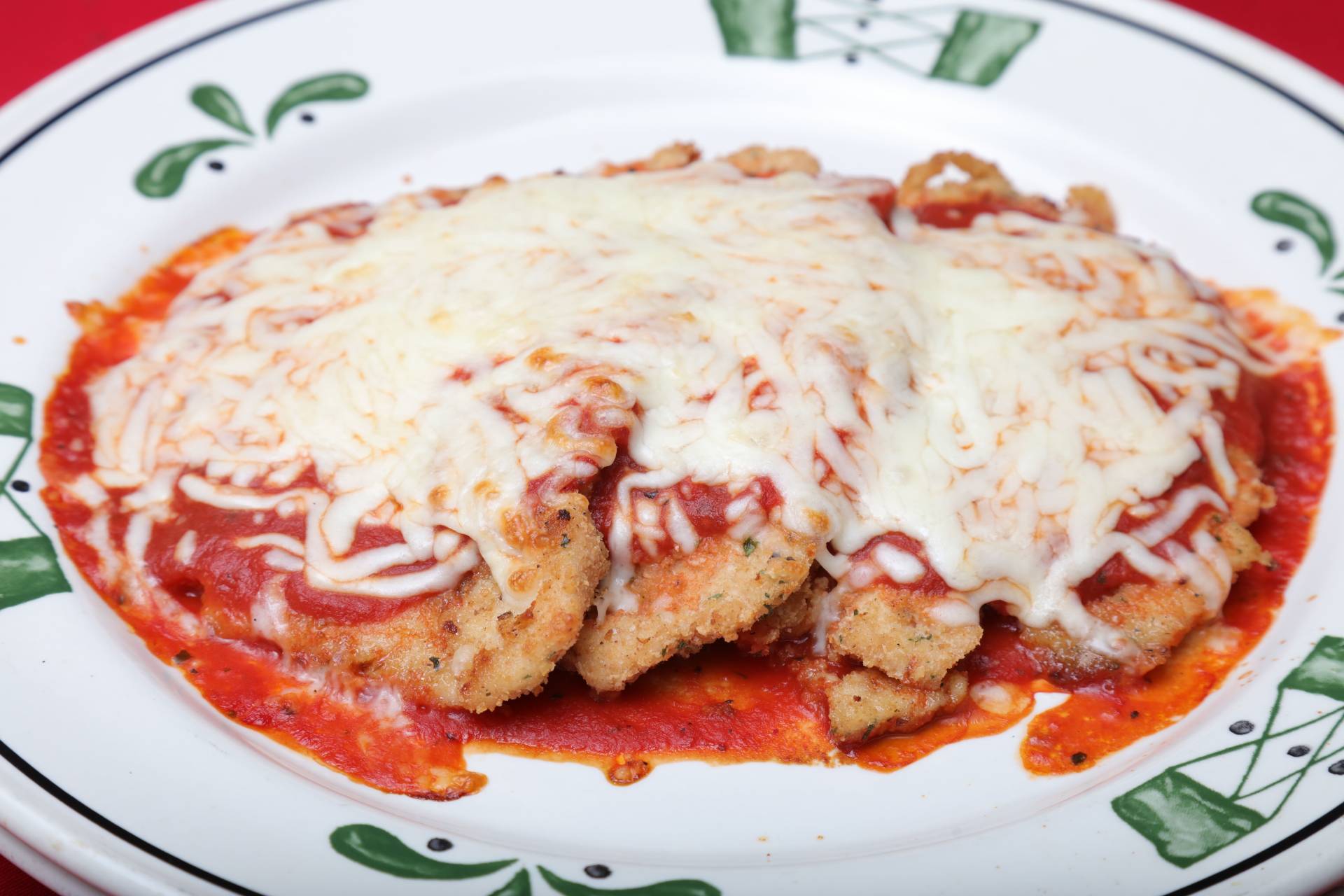 A plate of food with some type of sauce and cheese.